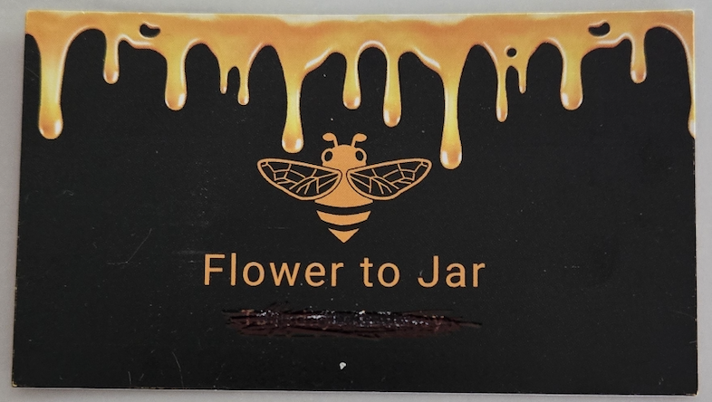 Flower to Jar business card with a golden bee and dripping honey design